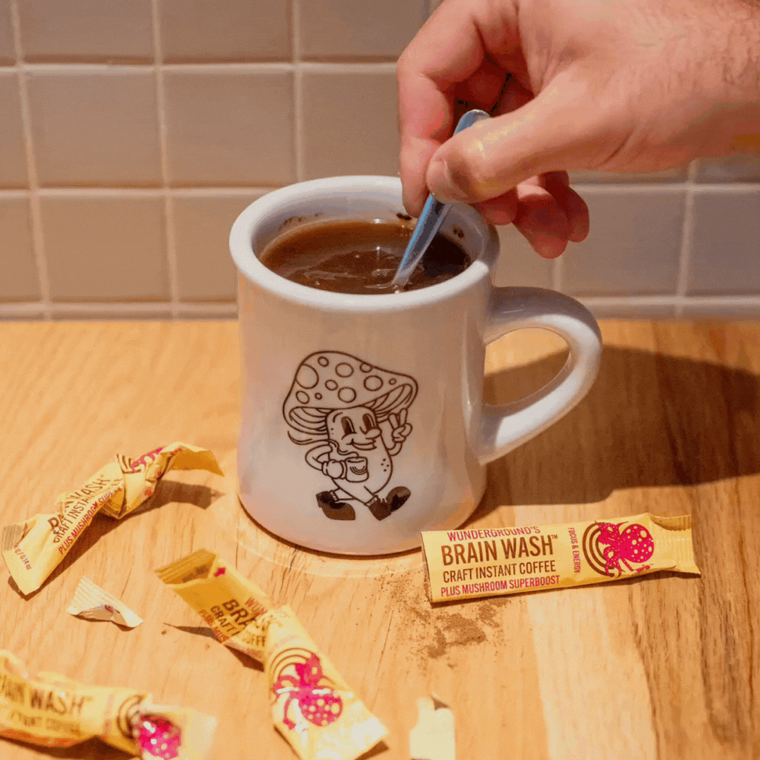 Brain Wash coffee being stirred with single-serve sticks on table